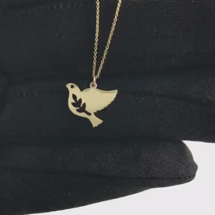 gold plated 92.5 sterling silver dove pendant in hand