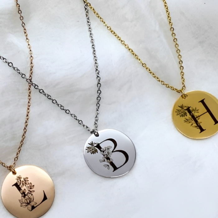 Display of 3 pendants on which the birthflower and Initials are engraved these are sold exclusively by CHOKHA INDIA perfect for any occasion. This is a perfect gift 