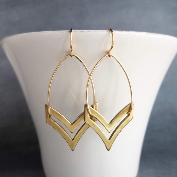 chevron earrings by chokha india hanging from a cup 