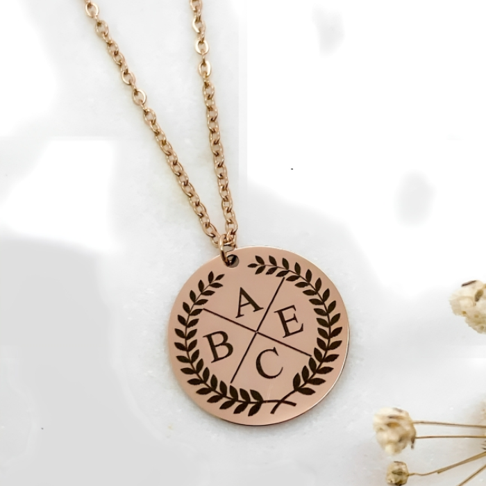 sterling silver pendant in rose gold plating  with four initials masrked on it