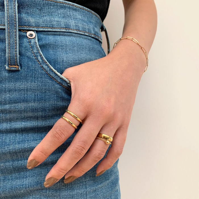 model wearing black top and blue jeans with double bar ring and serpentile ring by chokha india