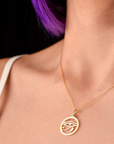 a model wearing eye of ra pendant with white dress