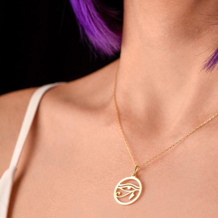 a model wearing eye of ra pendant with white dress