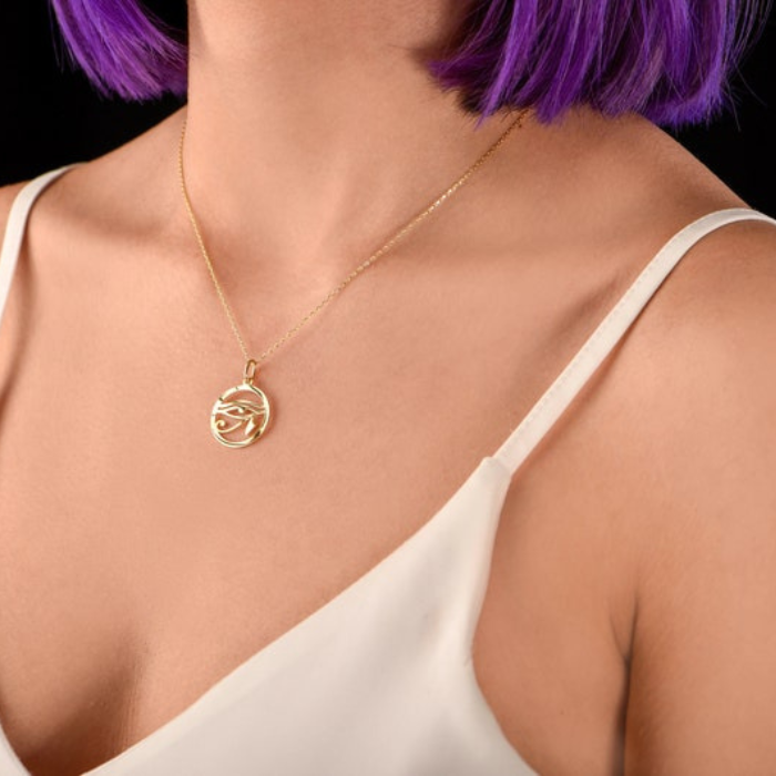 model wearing "Sterling silver Eye of Ra pendant on a delicate chain"
