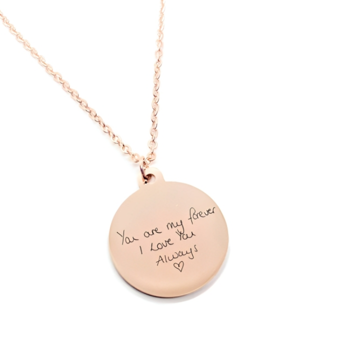 A circle shaped rose gold plated pendant on which you can get your message engraved on it 