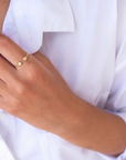 Model wearing white shirt with dainty two star ring which is gold plated 