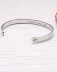 sterling silver bracelet cuff designed specially for cancer patients and survivors . A quote fuck cancer is written on the inside